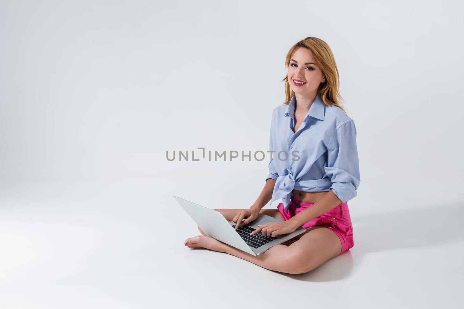 young woman sitting on the floor and using laptop by nazarovsergey