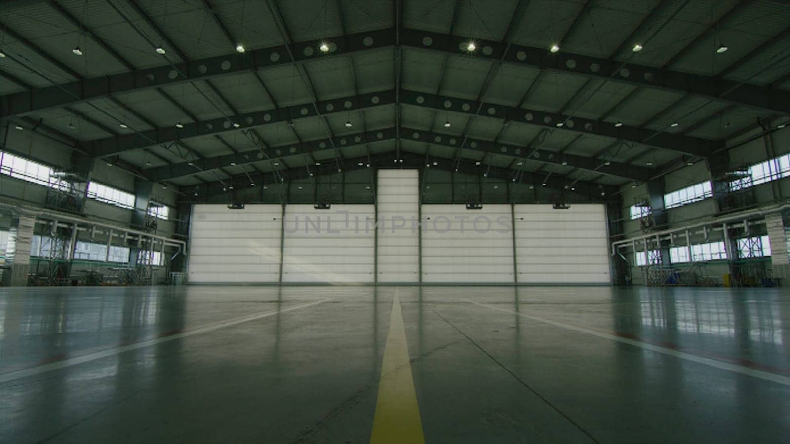 Roll or shutter door in airport hangar. Shutter door or roller door and concrete floor inside factory building for industry background. corrugated metal doors of Commercial Building HD
