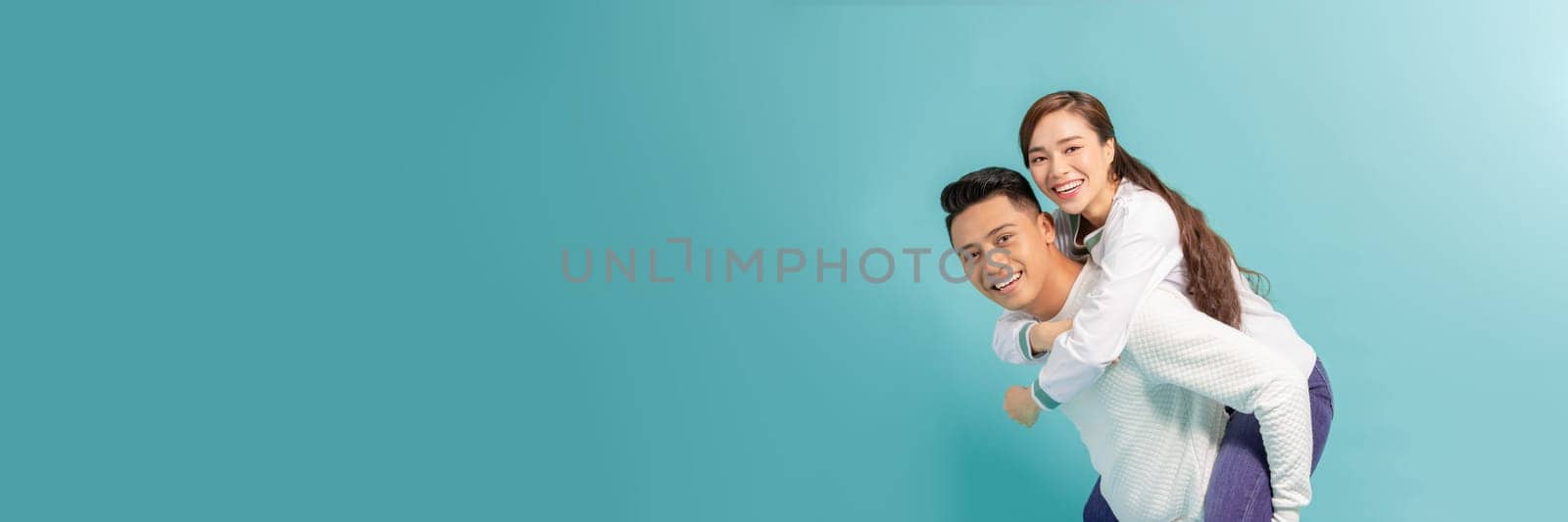 Young beautiful couple isolated on light blue background by makidotvn
