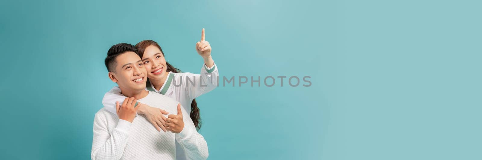 Attractive woman is indicating direction and pointing with index finger the way