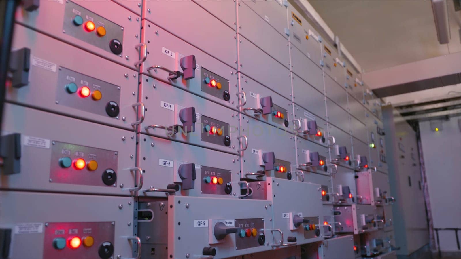 Electric control station shield. Action. Industrial electrical equipment with multiple control cells. Many buttons light up on control panels in electrical industry.