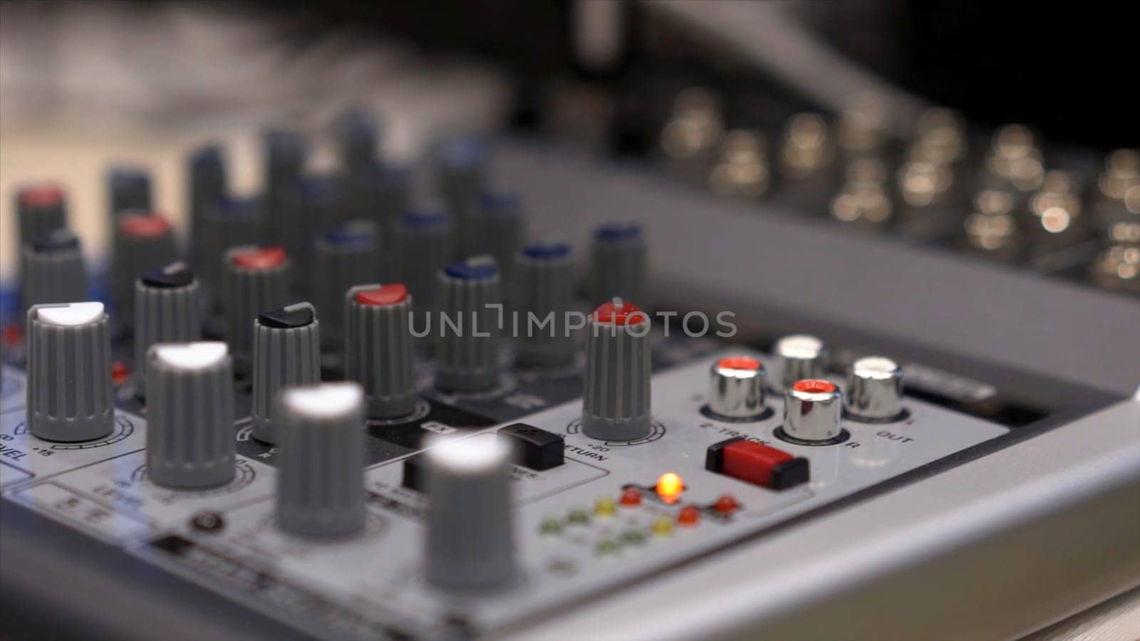 Close-up of mixing console. Stock. Close up multi color buttons of sound mixer console, shallow depth of field DOF .