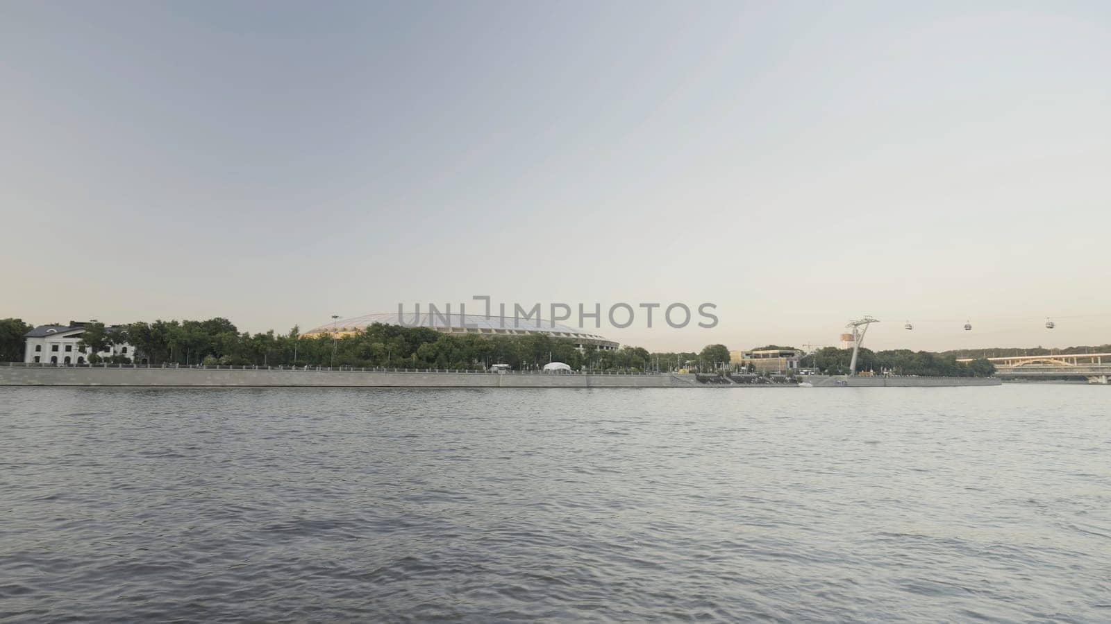 Moscow river, view from the ship with time lapse effect on sunset sky background. Action. Ship sailing along the embankment of the Moscow city