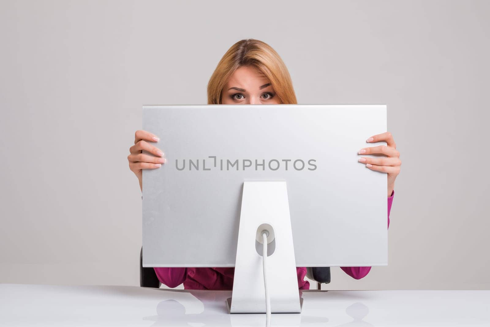 young woman sitting in the table and using computer by nazarovsergey