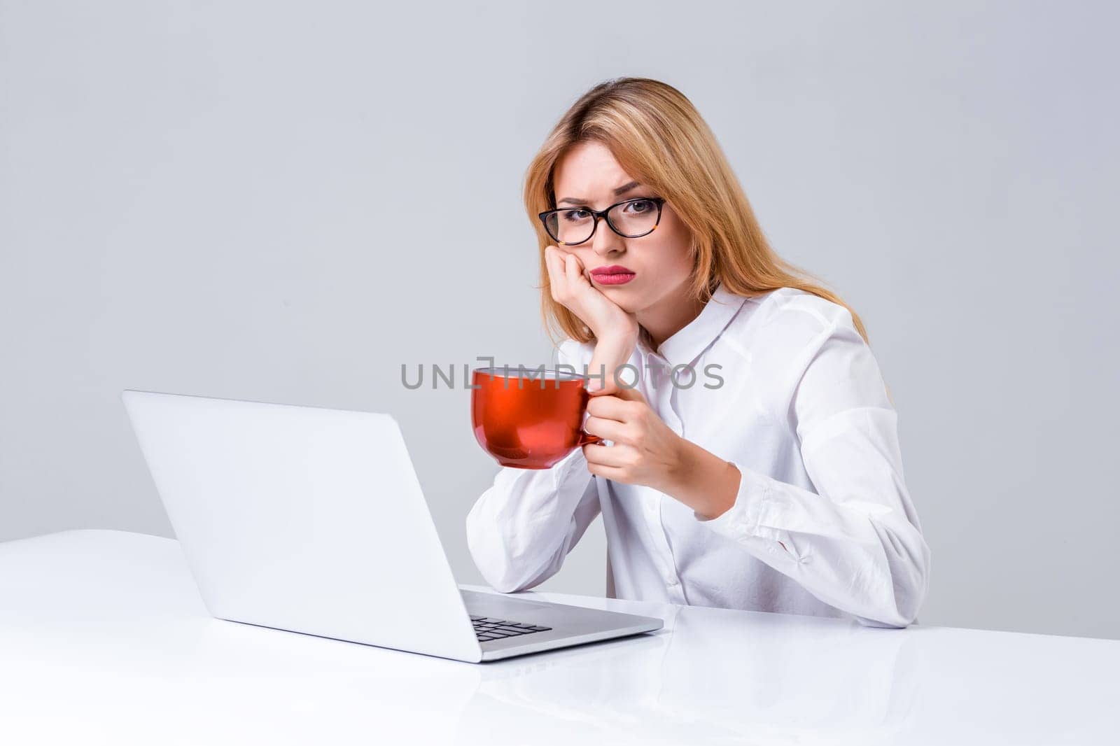 young woman sitting in the table and using laptop by nazarovsergey