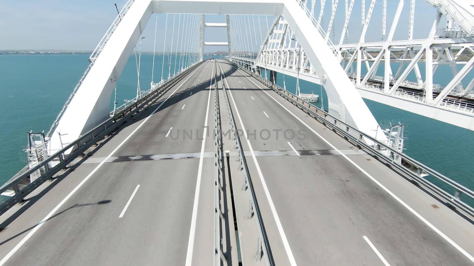 A huge bridge is a bird's-eye view. Action. A long new bridge built for the movement of transport over the big sea. High quality 4k footage
