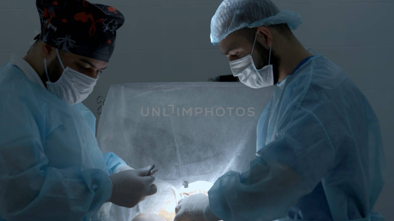 Surgery operation at a hospital. Action. Surgeons during medical procedure, treatment concept. by Mediawhalestock