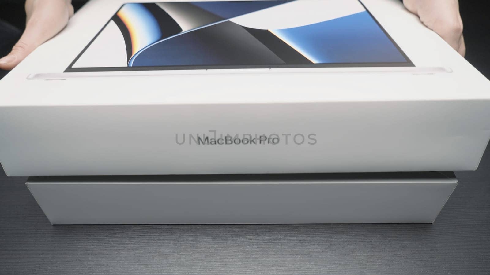 China, Beijing - April 22, 2023: Close-up of new laptop model. Action. Unpacking new MacBook model from Apple. New laptop from Apple for professional design work.