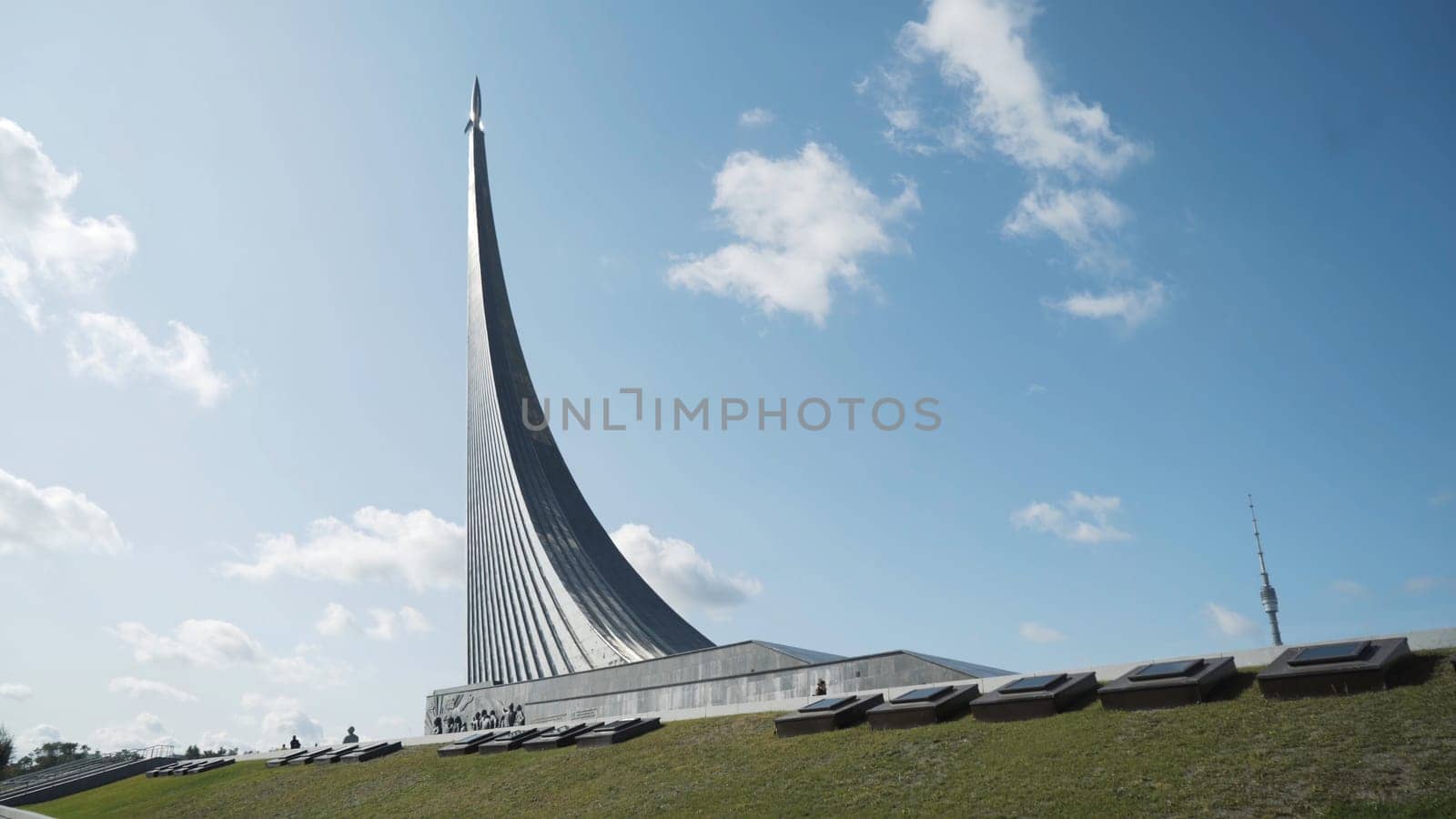 Monument to the conquerors of space located in Moscow, Russia. Summer sunny day and the museum of space with gorgeous monument in a form of a rocket.