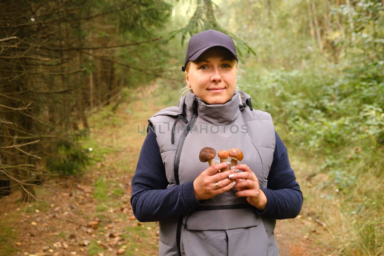 A mushroom picker holds in his hands an aspen bush growing in the forest. Mushrooms in the forest. Mushroom picking.