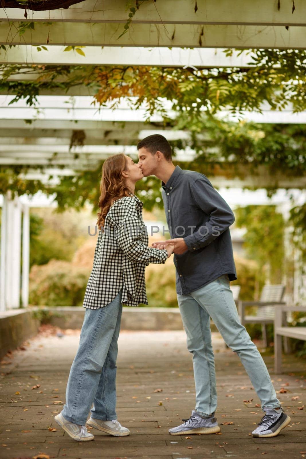 Young Cute Female Hugs Boyfriend. In Autumn Outdoor. Lovers Walking in Park. Attractive Funny Couple. Lovestory in Forest. Man and Woman. Cute Lovers in the Park. Family Concept. Happy Couple.