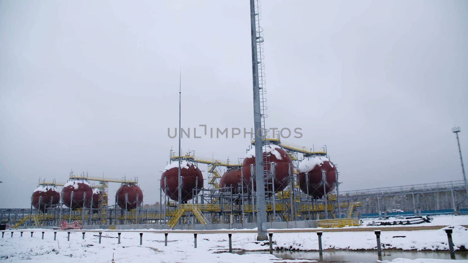Large Industrial tanks for petrol and oil. Large tanks in the chemical factory. Large tanks for storing fuel are outside.