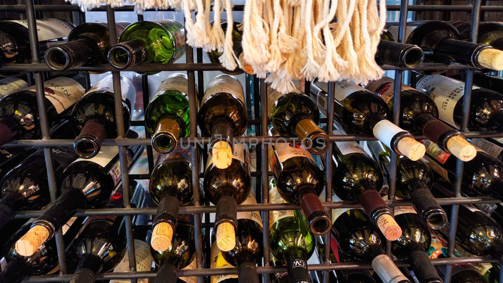 Kirov, Russia - May 08, 2023: Wine bottles stacked on wooden racks