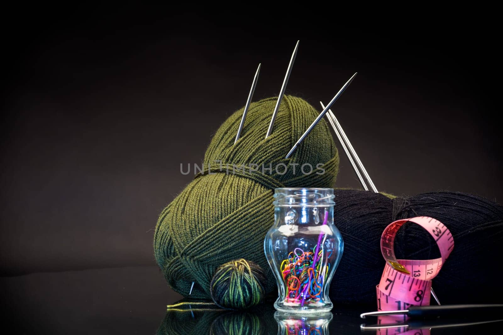 wool yarn, knitting needles and other tools for hand knitting. by Rawlik