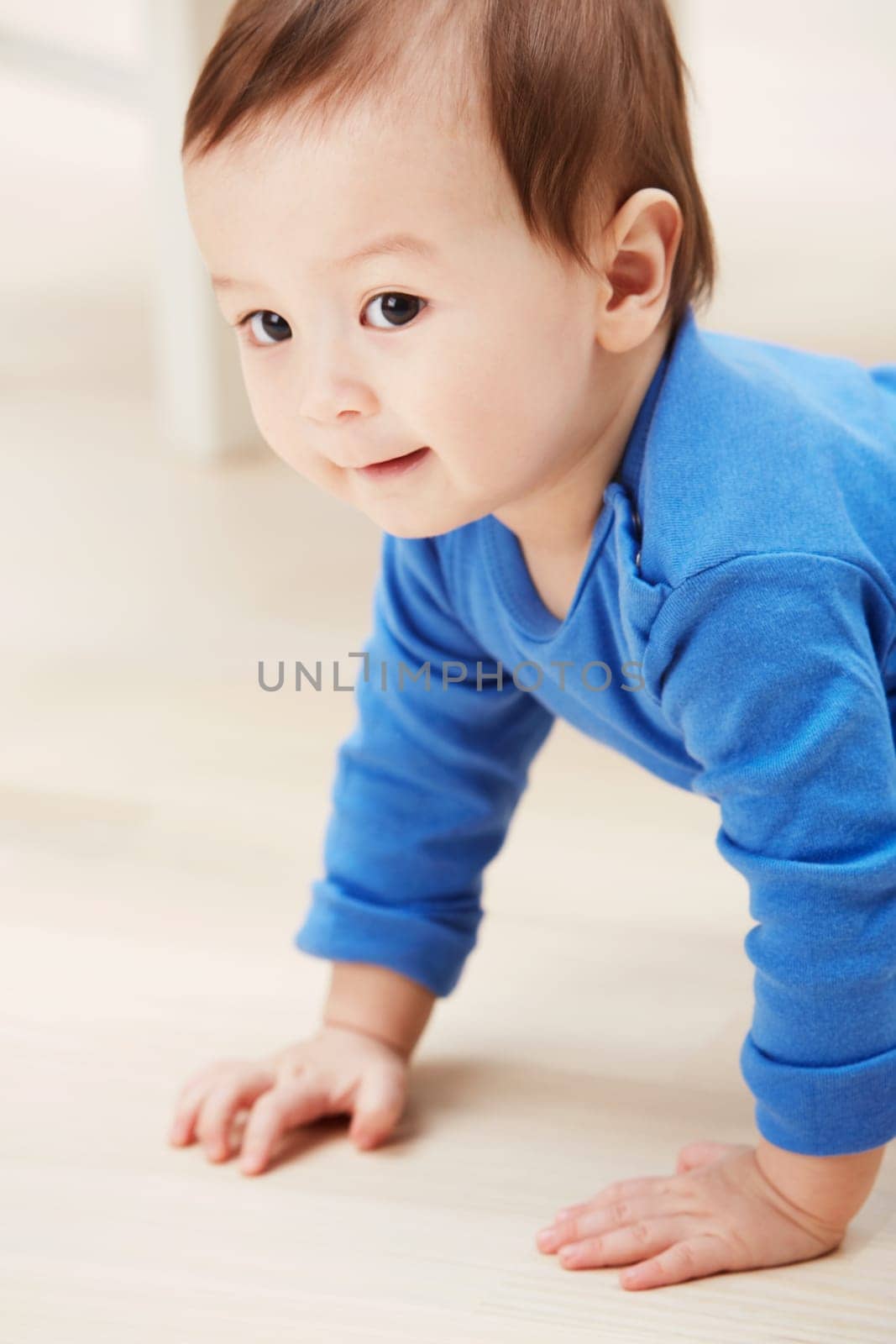 Cute, crawling and smile with baby on floor for child development, learning and youth. Young, curious and adorable with infant kid on ground of family home for growth, progress and first steps by YuriArcurs