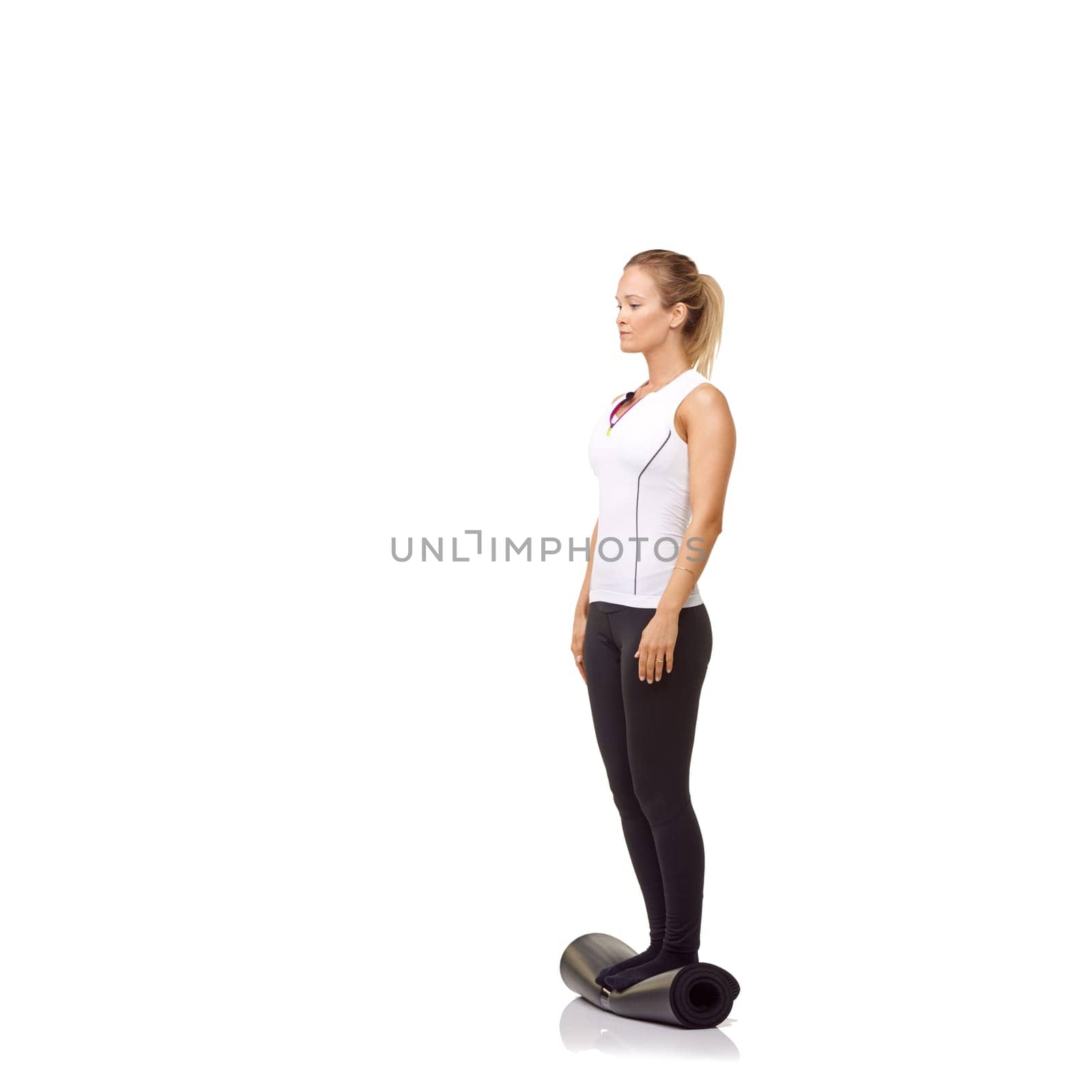Woman, balance and mat in studio for fitness, pilates or workout for healthy body, wellness or exercise. Person, face and yoga in sportswear for physical activity on mock up space or white background by YuriArcurs