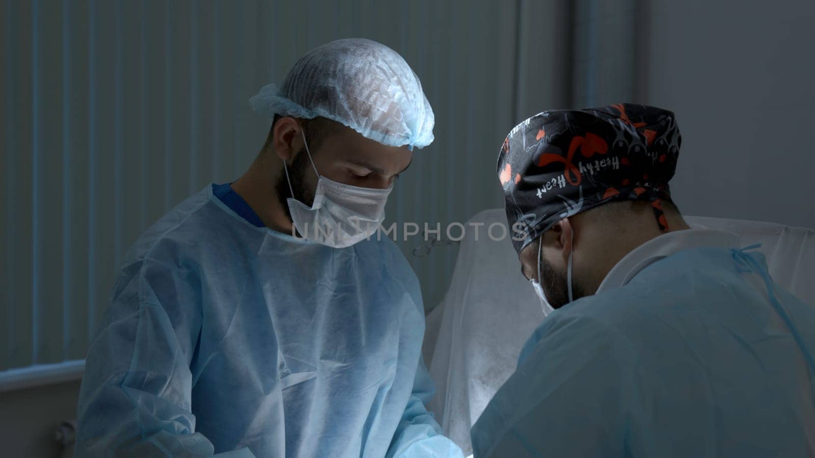 Surgery operation at a hospital. Action. Surgeons during medical procedure, treatment concept. by Mediawhalestock