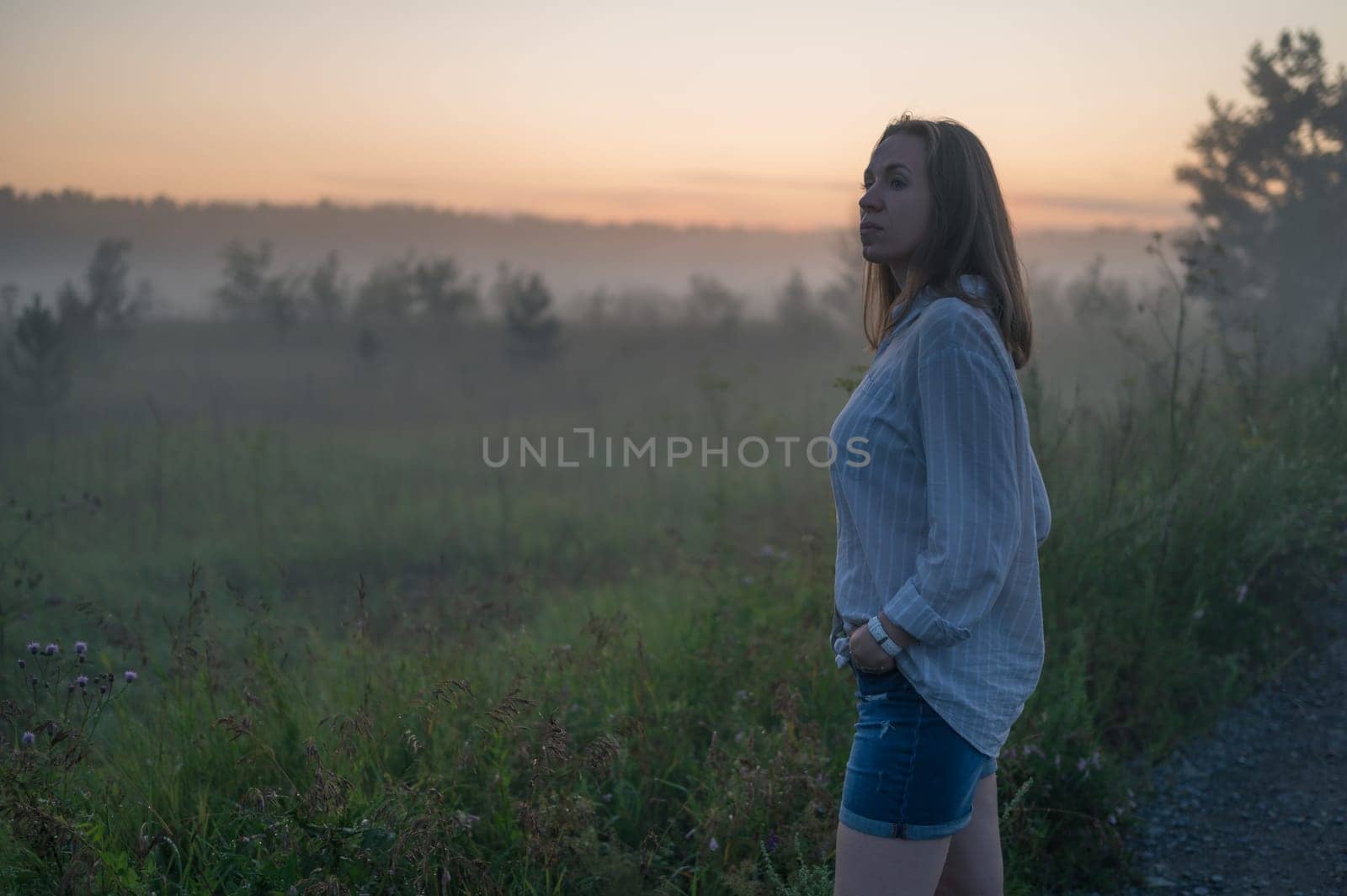 Woman in a field with fog by rusak