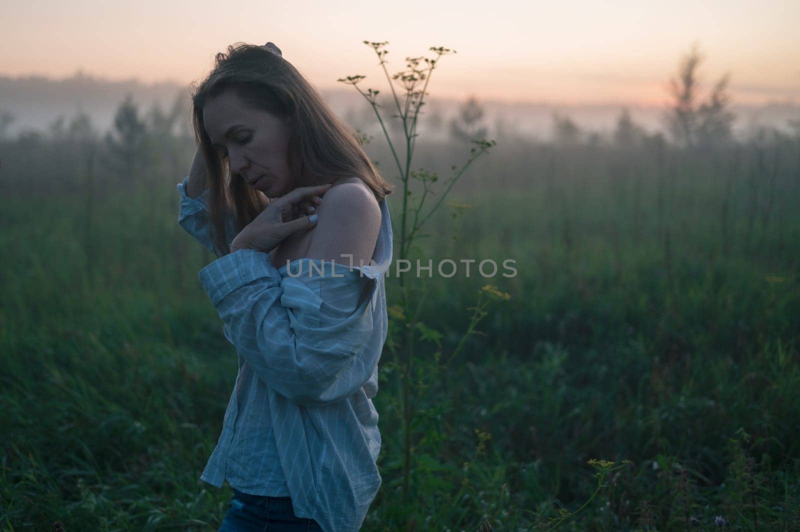 Woman in a field with misty fog