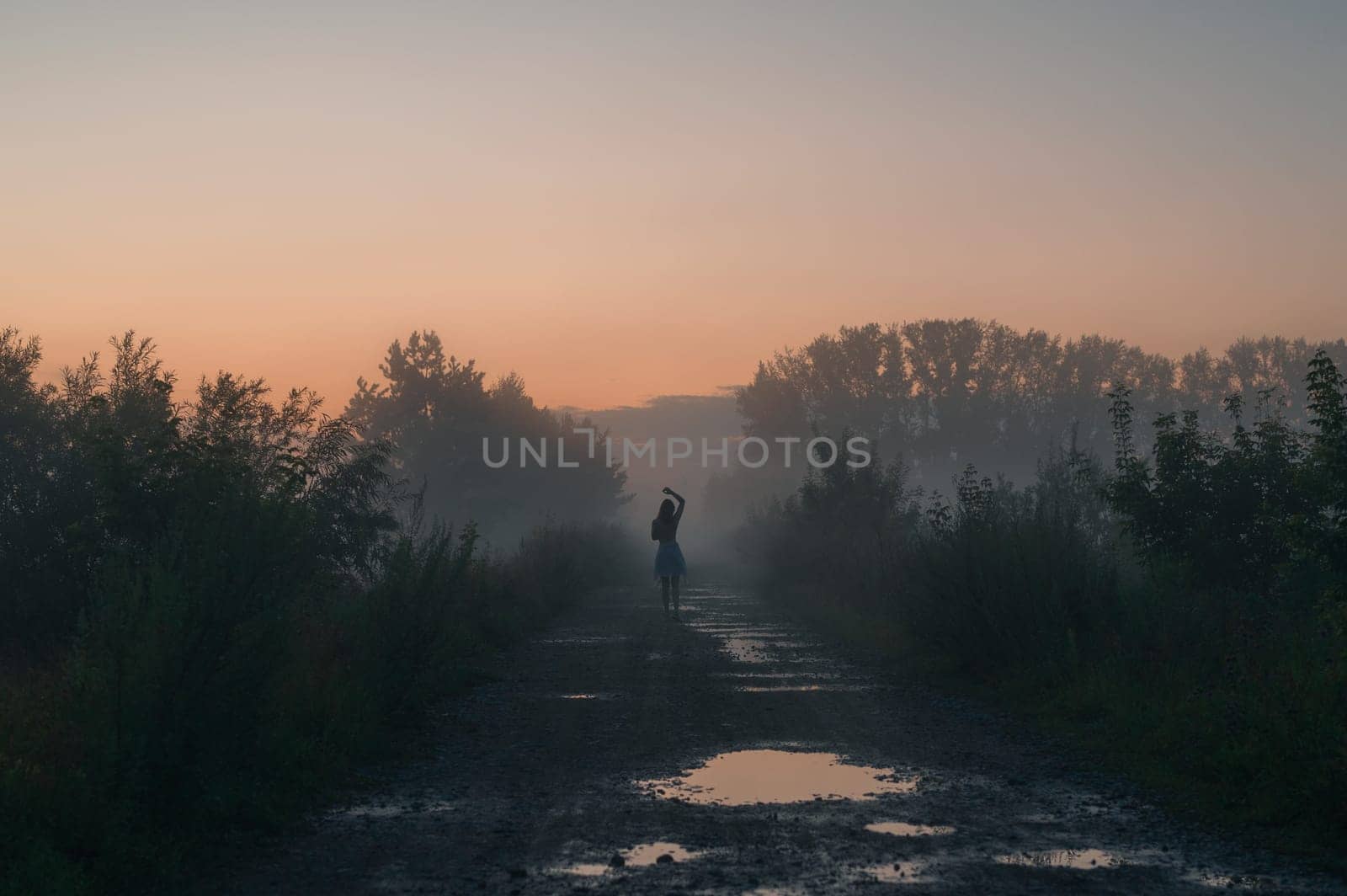 Woman in beautiful misty fog, summer landscape