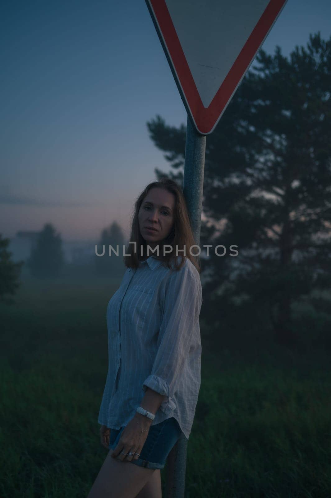 Woman in a field with misty fog