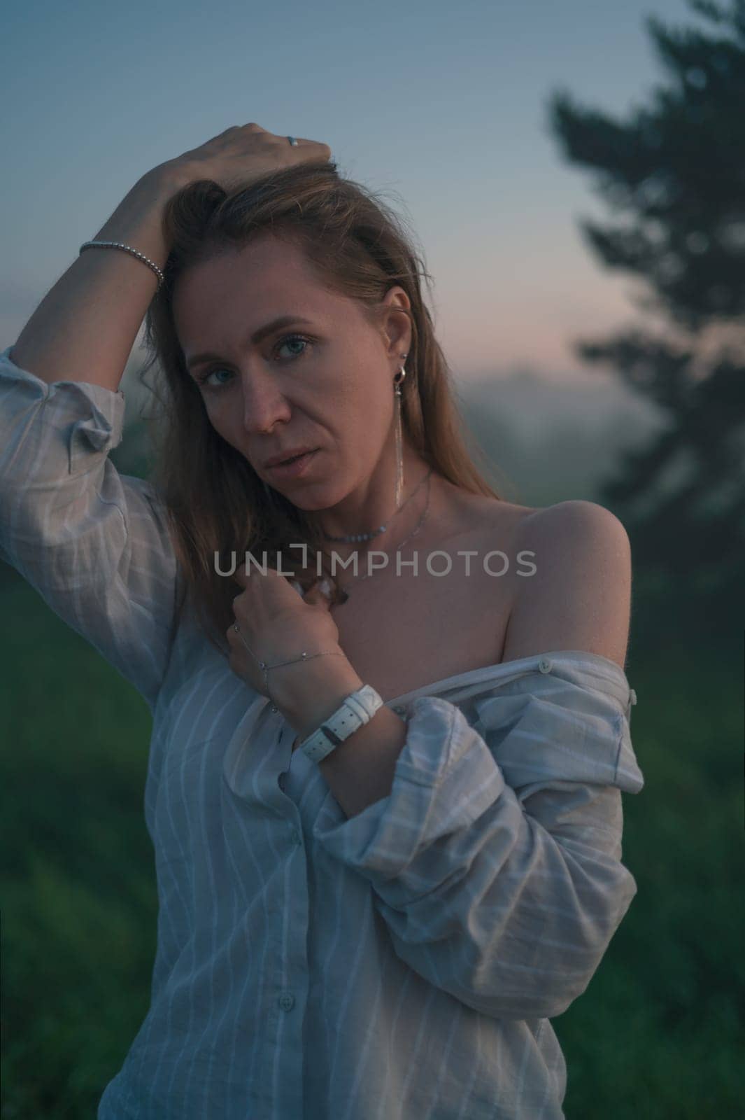 Woman in a field with misty fog