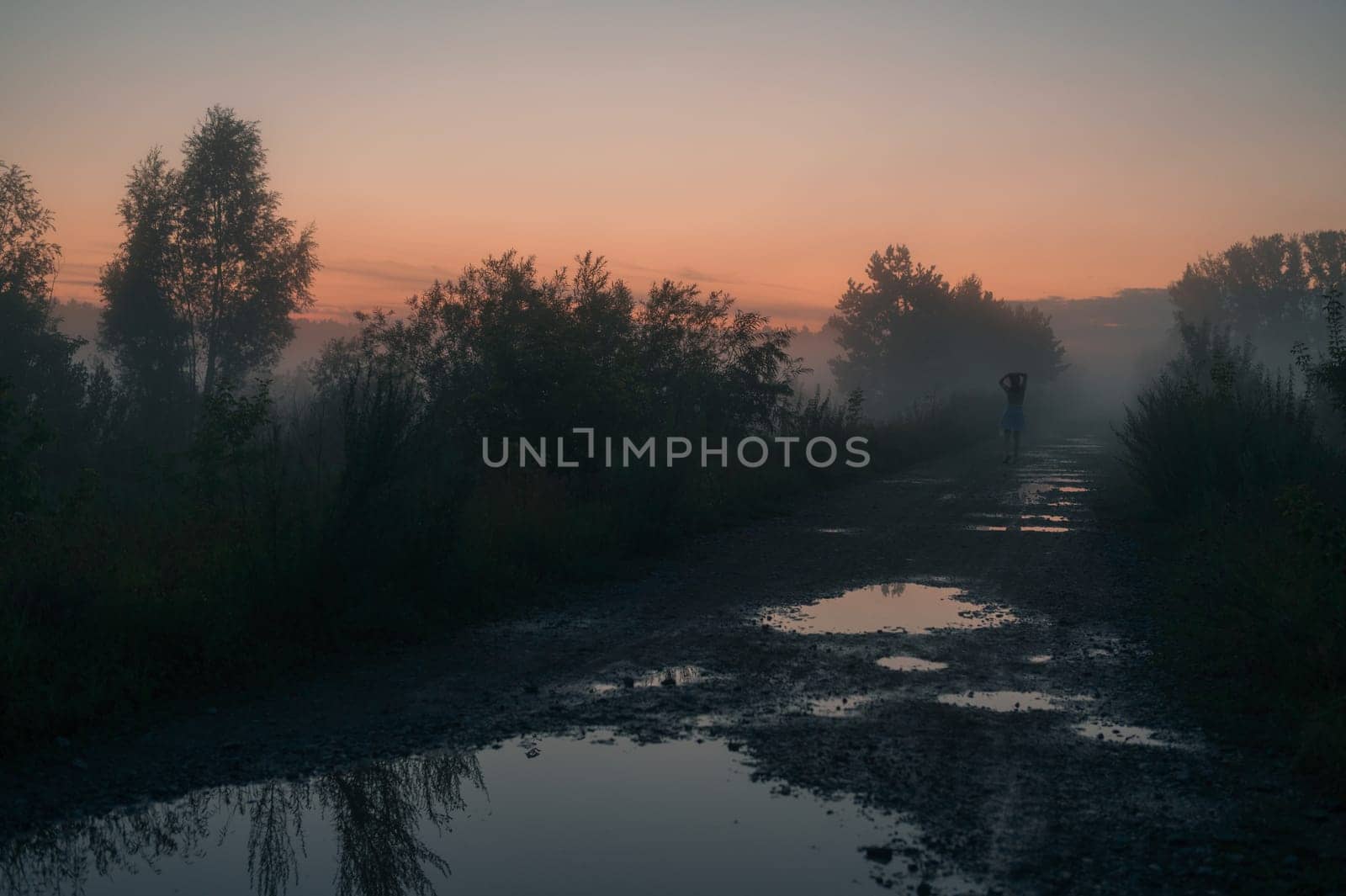 Woman in beautiful misty fog, summer landscape