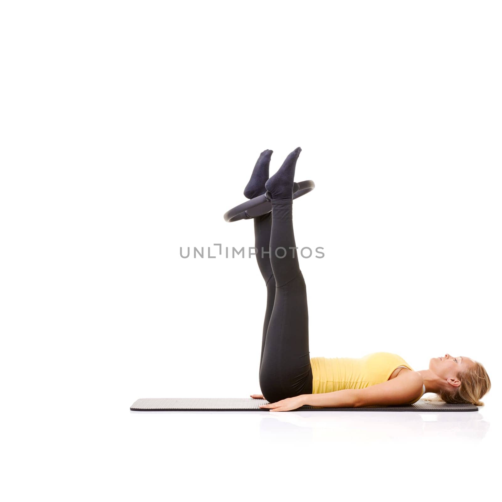 Woman, pilates ring and legs for workout on yoga mat for resistance training, strong thighs or studio white background. Female person, equipment for muscle flexibility or exercise, health or mockup.