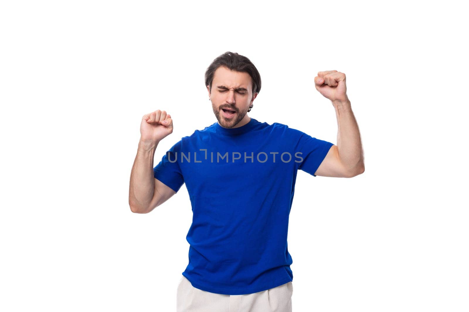 emotional young brunette man with a beard dressed in a blue t-shirt on a white background.