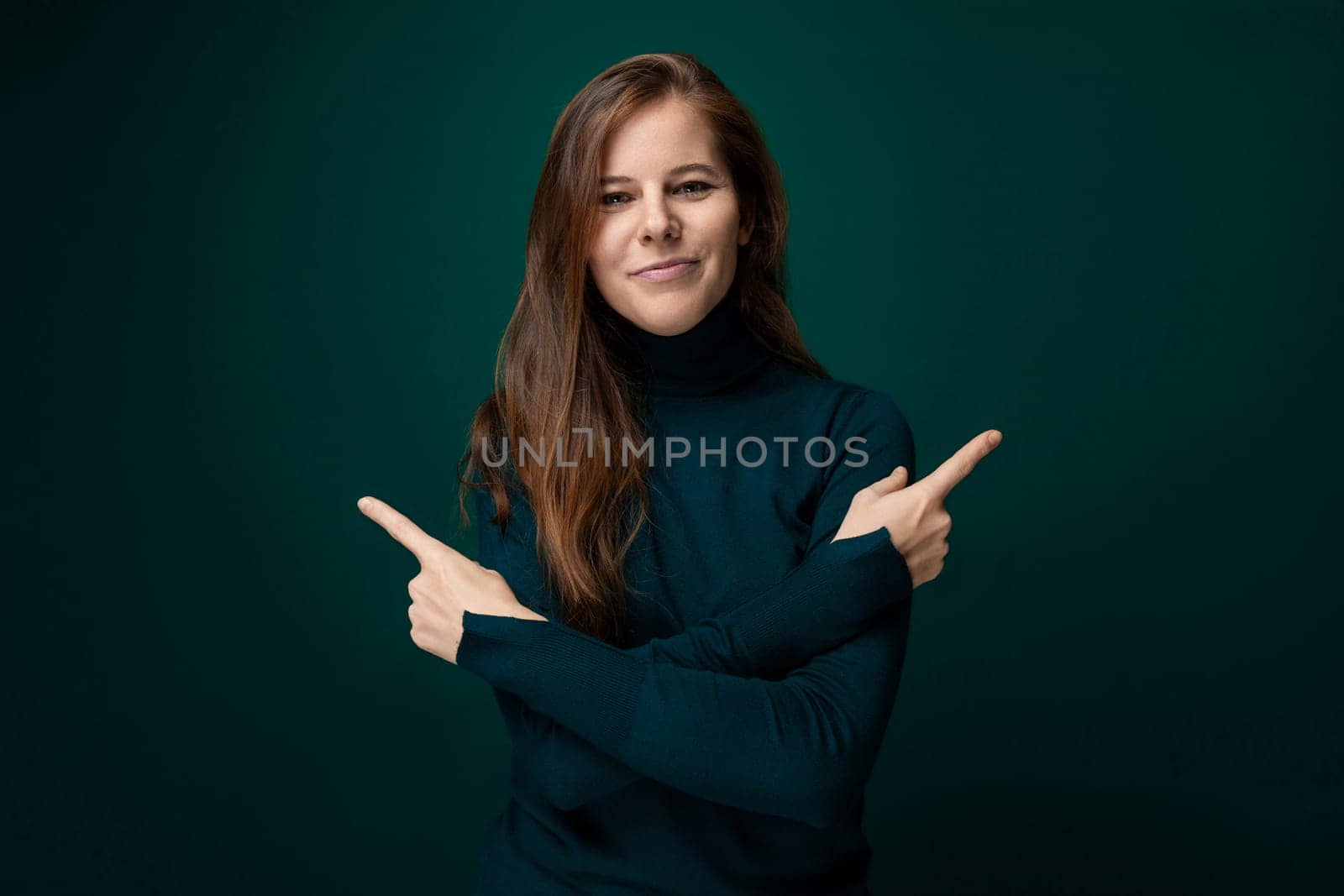 Portrait of a charismatic young woman with brown eyes wearing a green turtleneck by TRMK