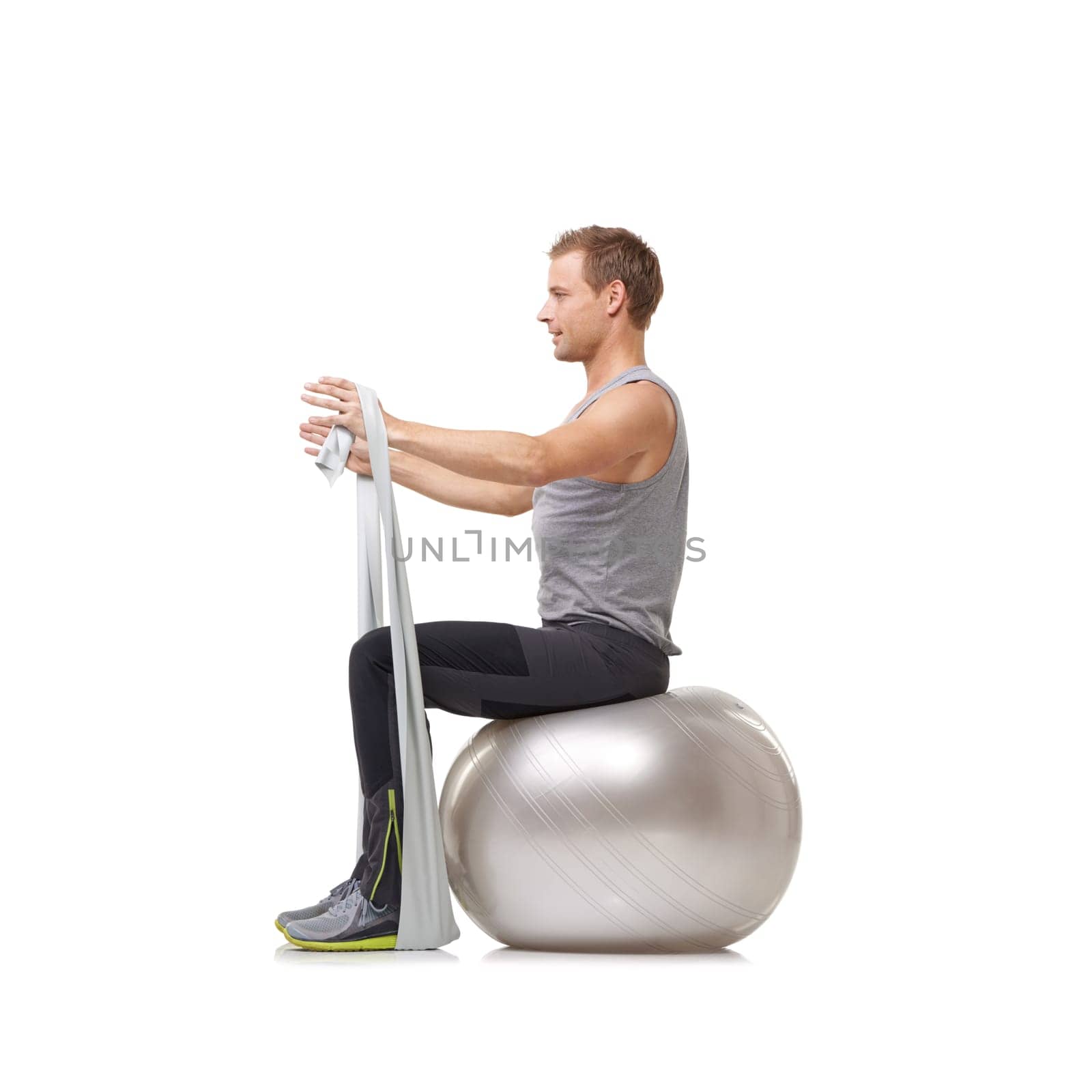 Yoga ball, resistance band and man doing workout in studio for health, wellness and bodycare. Sport, fitness and young male person from Australia with arms exercise or training by white background. by YuriArcurs