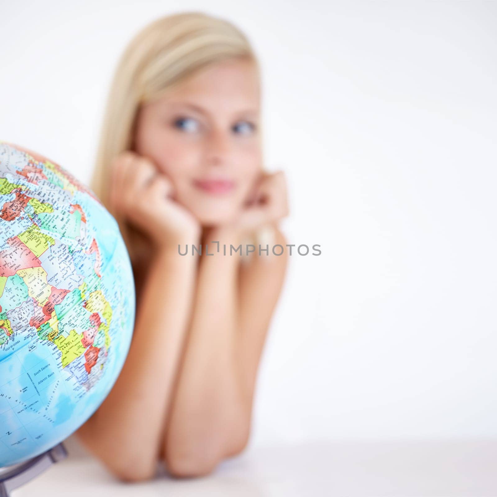 Globe, earth and a woman thinking about travel in studio on a blurry white background for freedom. Planet, map or atlas and a tourist with an idea for a holiday or vacation destination on the world.