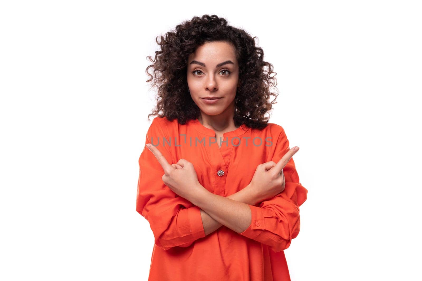 young successful caucasian business woman with curly hairstyle dressed in orange shirt.