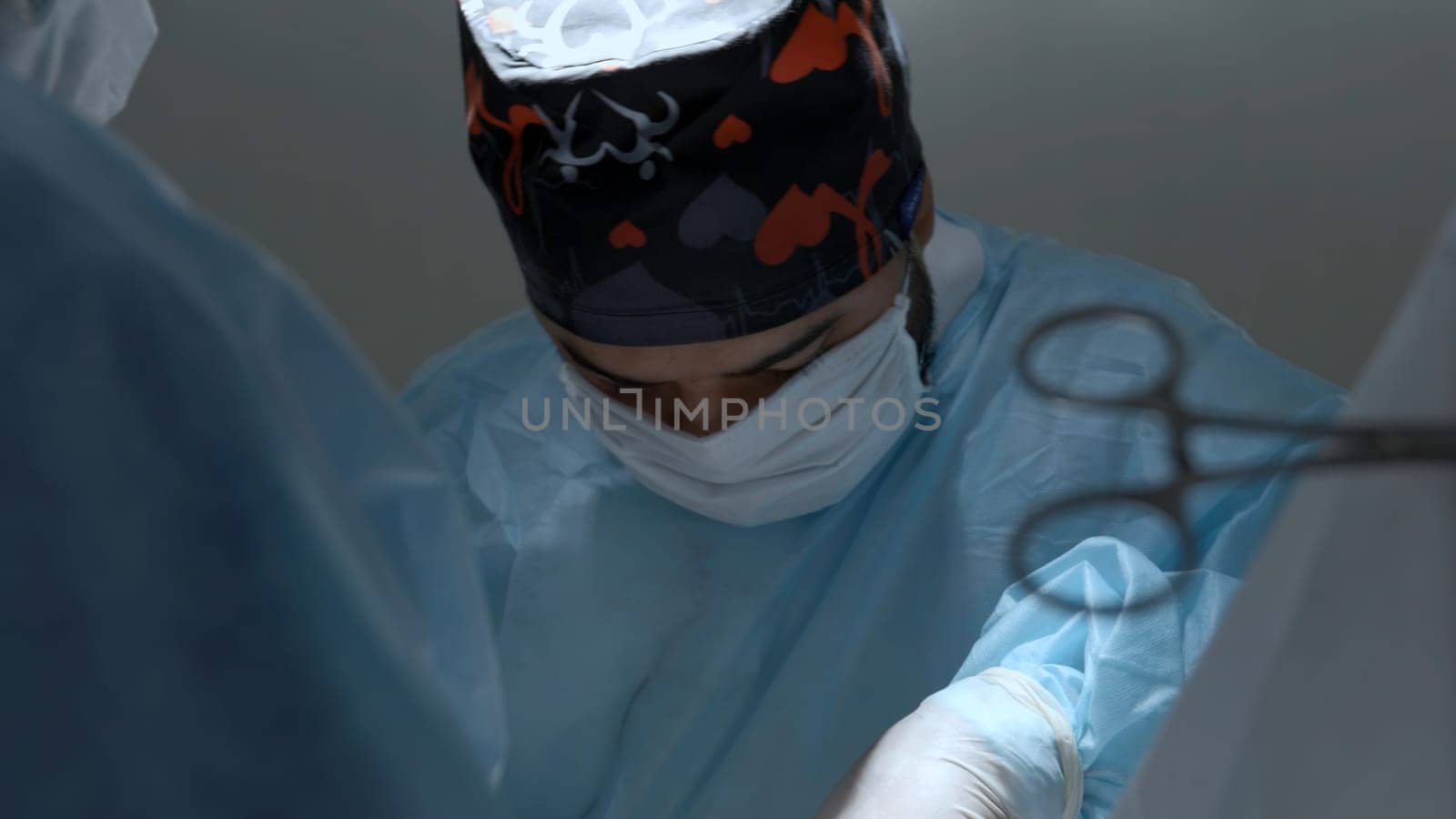 Portrait of surgeon wearing medical mask standing in operation theater at a hospital. Action. Healthcare, emergency medical service concept