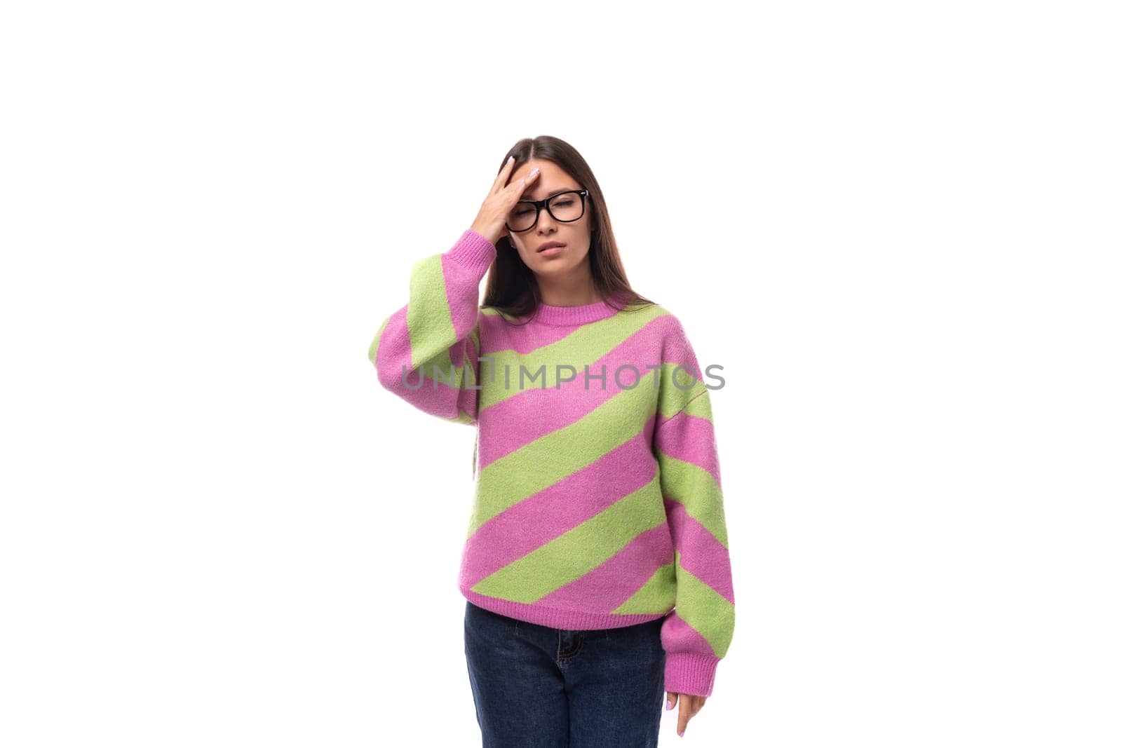 portrait of a smart young brunette woman in a casual stylish pink-green sweater with glasses for vision on a white background with copy space by TRMK