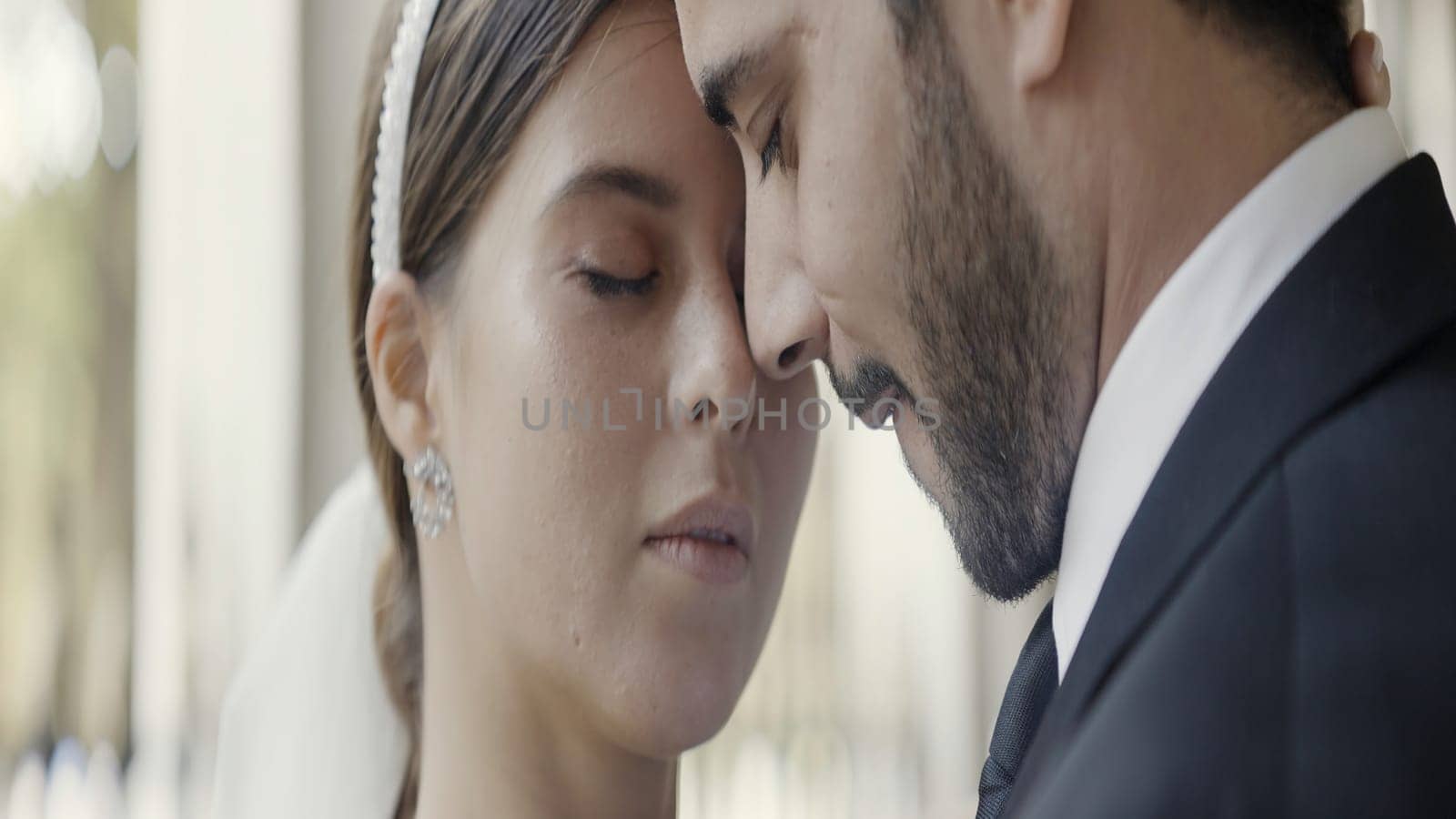A couple enjoying each other. Action. An adult man with stubble and a cute woman with makeup are bumping into each other's face. High quality 4k footage