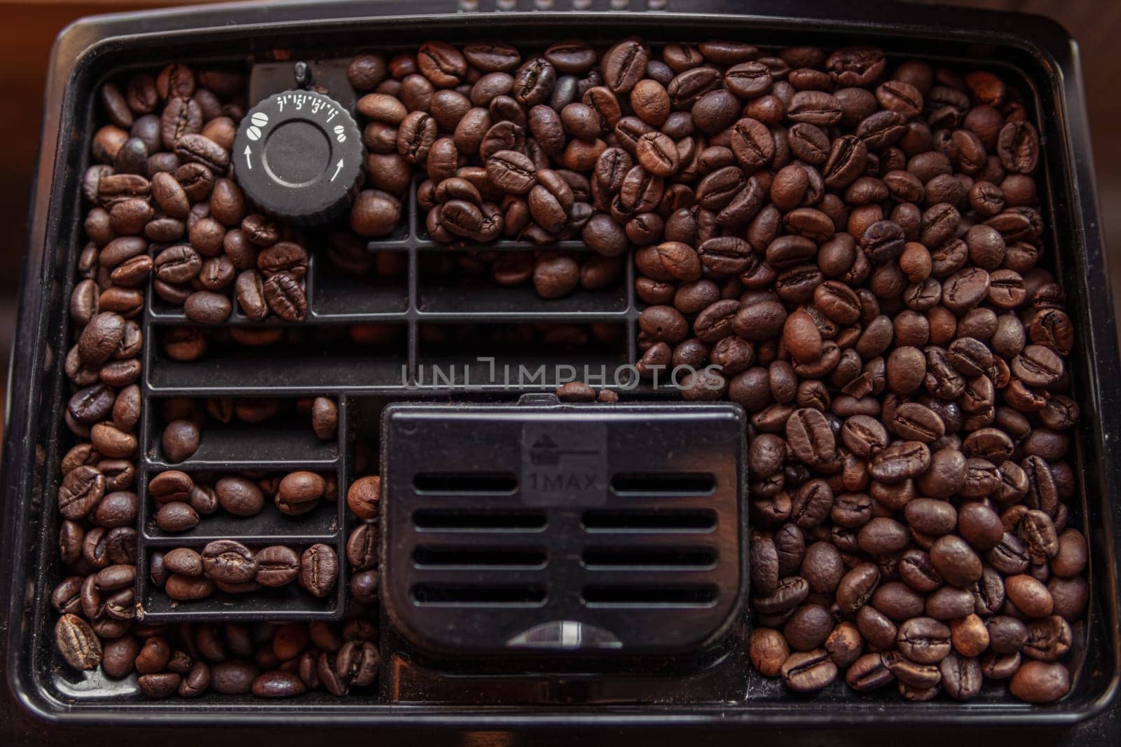 coffee beans in a coffee machine close up, close up of coffee beans in a coffee maker by PopOff