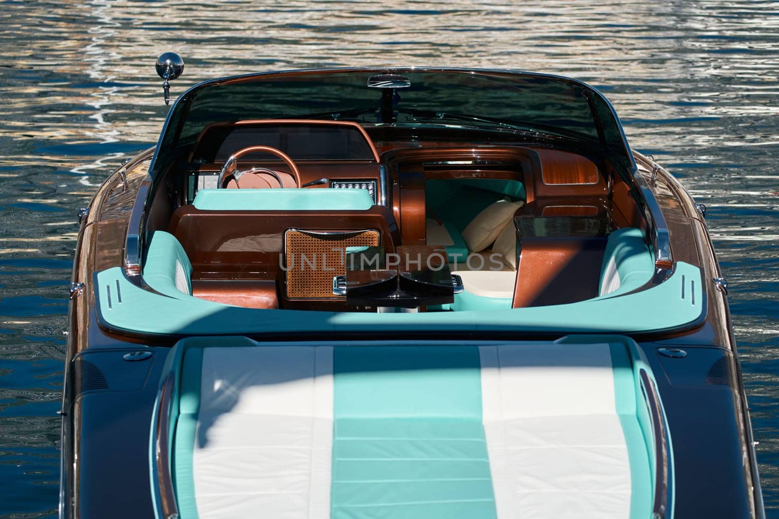 Interior of the luxury motor boat, port of Hercules in Monaco, sunny glare of the sun on the water, powerful boat, glossy surfaces shine in sunny weather. High quality photo