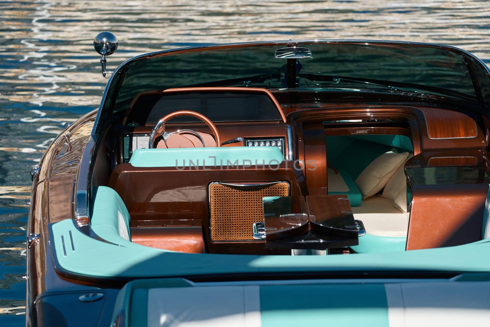 Interior of the luxury motor boat, port of Hercules in Monaco, sunny glare of the sun on the water, powerful boat, glossy surfaces shine in sunny weather. High quality photo