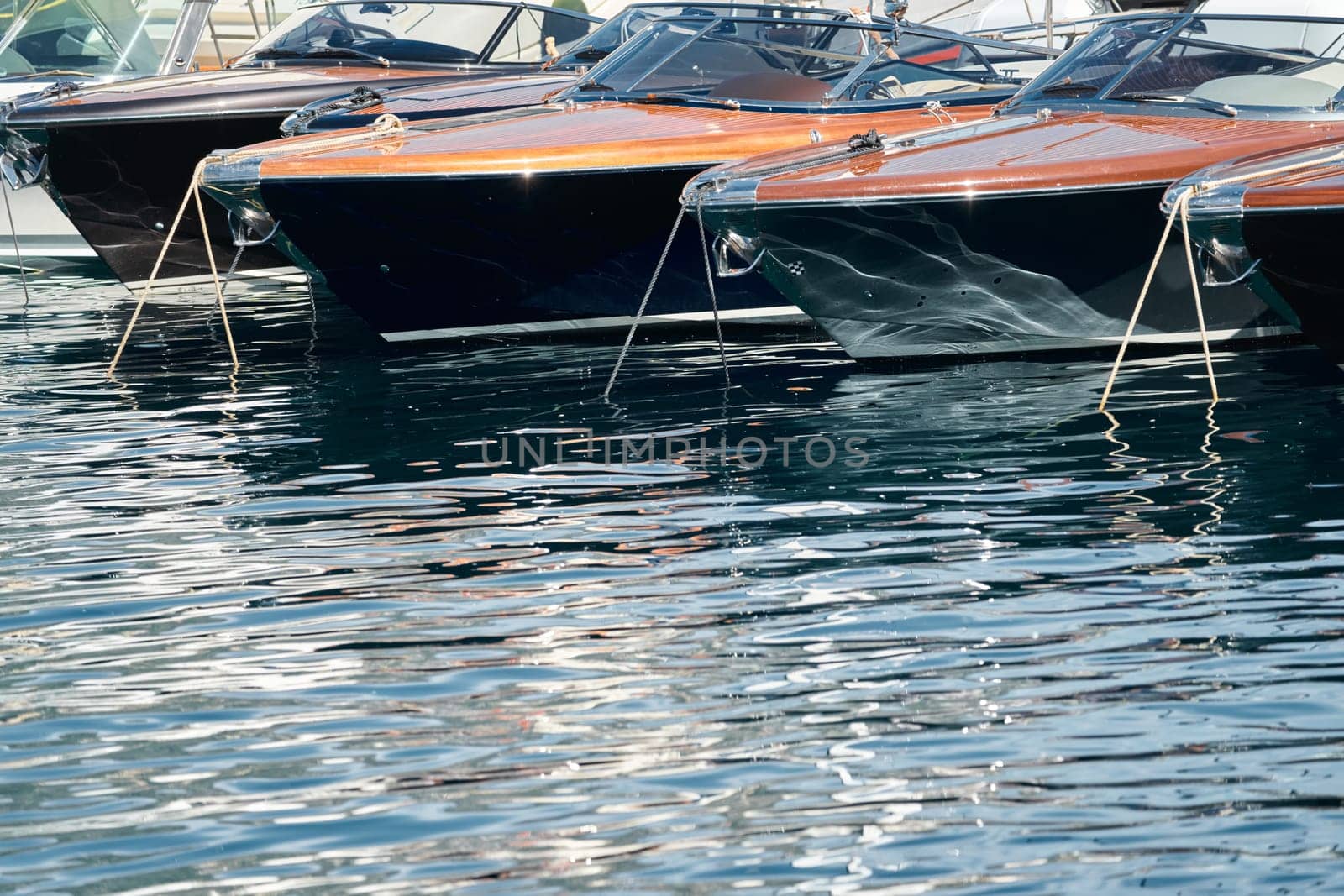 Few luxury retro motor boats in row at the famous motorboat exhibition in the principality of Monaco, Monte Carlo, the most expensive boats for the richest people, boats for rich clients. High quality photo