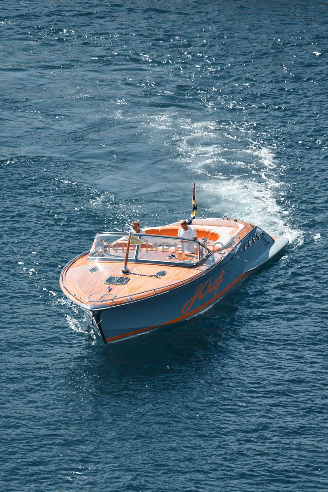 a boat with guests of yacht brokers departs from the shore in the largest fair exhibition in the world yacht show MYS, port Hercules, rich clients, sunny by vladimirdrozdin