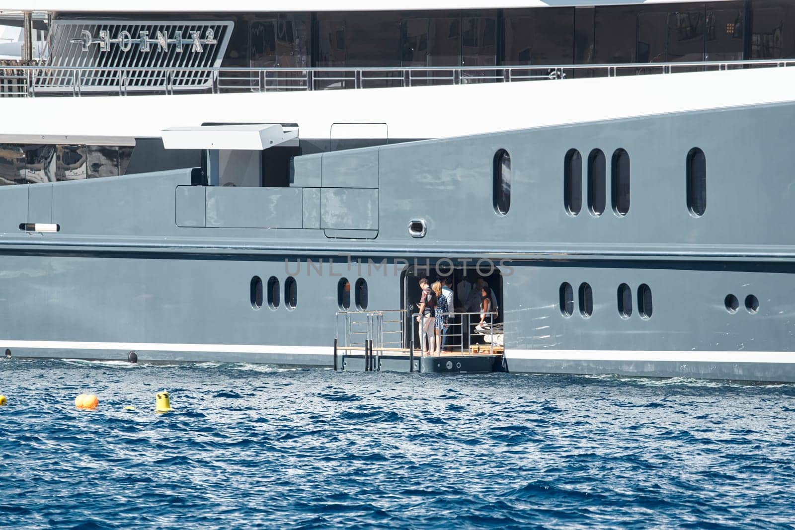 Invited wealthy clients inspect megayachts at the largest fair exhibition in the world yacht show MYS, port Hercules, yacht brokers, sunny weather by vladimirdrozdin