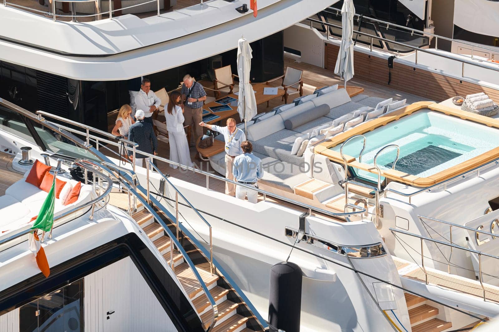 Monaco, Monte Carlo, 28 September 2022 - Invited wealthy clients inspect megayachts at the largest fair exhibition in the world yacht show MYS, port Hercules, yacht brokers, sunny weather. High quality photo