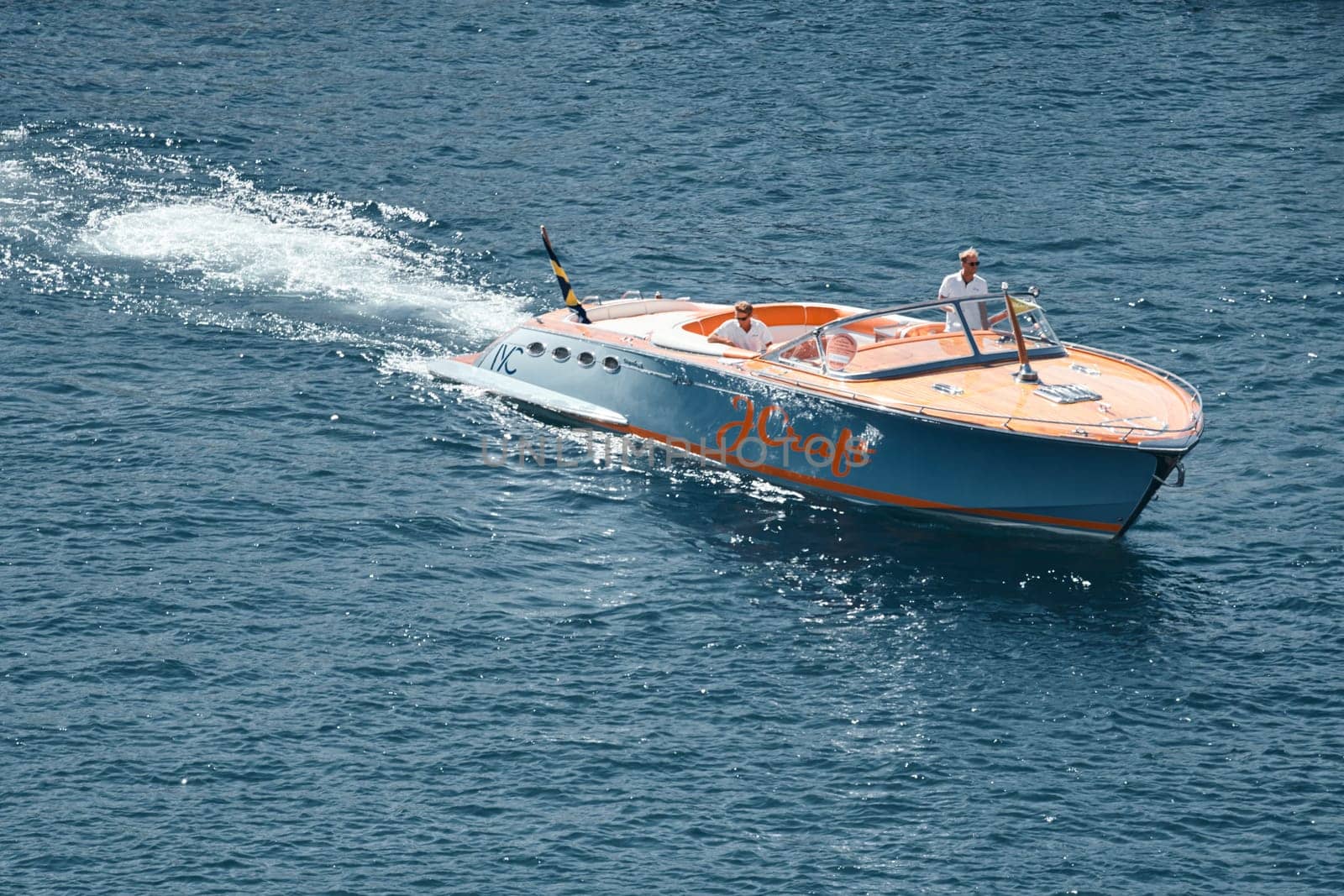 Monaco, Monte Carlo, 28 September 2022 - a boat with guests of yacht brokers departs from the shore in the largest fair exhibition in the world yacht show MYS, port Hercules, rich clients, sunny. High quality photo