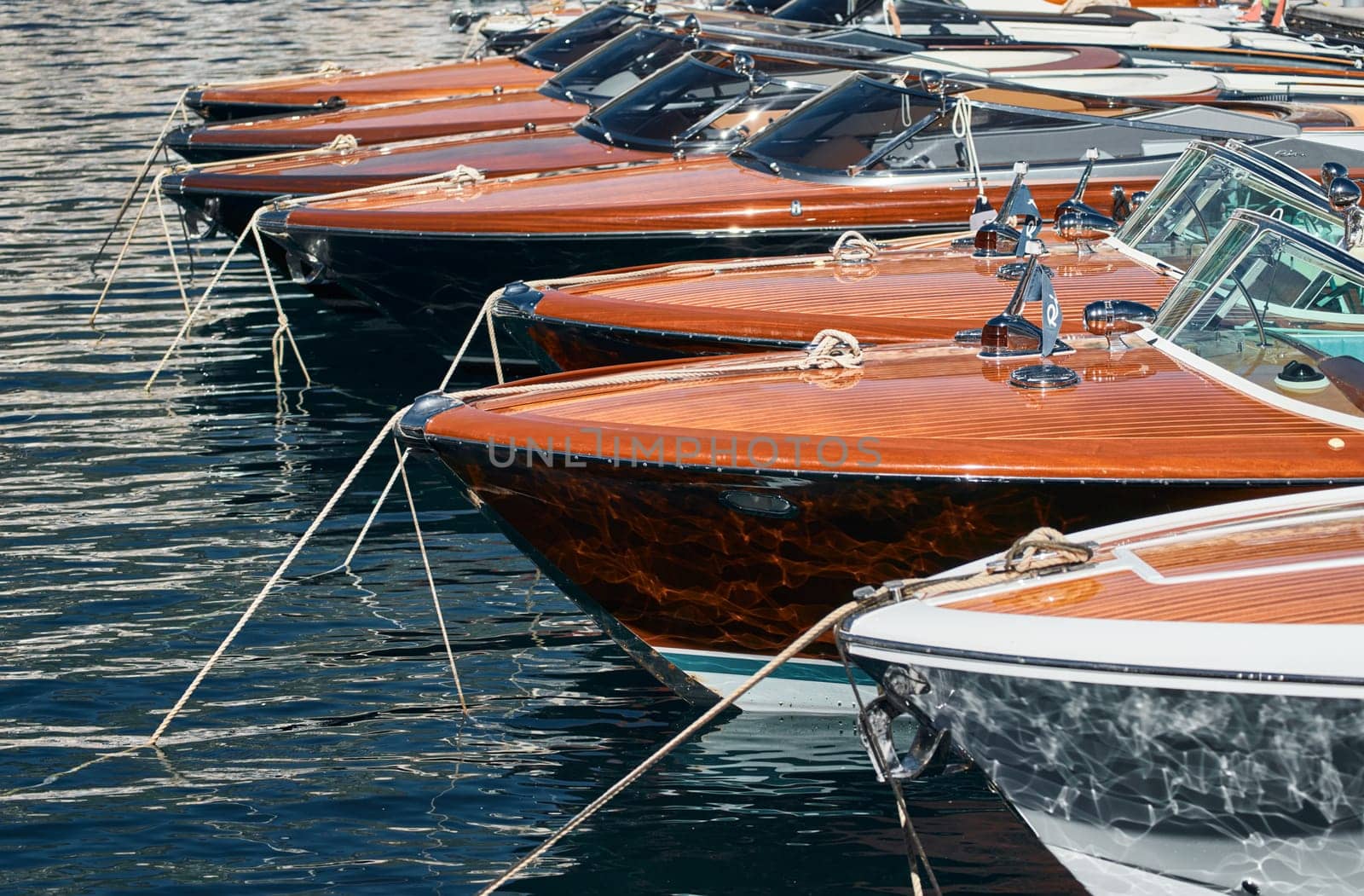 Few luxury retro motor boats in row at the famous motorboat exhibition in the principality of Monaco, Monte Carlo, the most expensive boats for the richest people, boats for rich clients by vladimirdrozdin