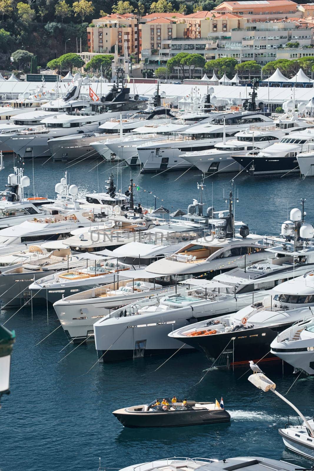 Monaco, Monte Carlo, 28 September 2022 - a boat with guests of yacht brokers departs from the shore in the largest fair exhibition in the world yacht show MYS, port Hercules, rich clients, sunny. High quality photo