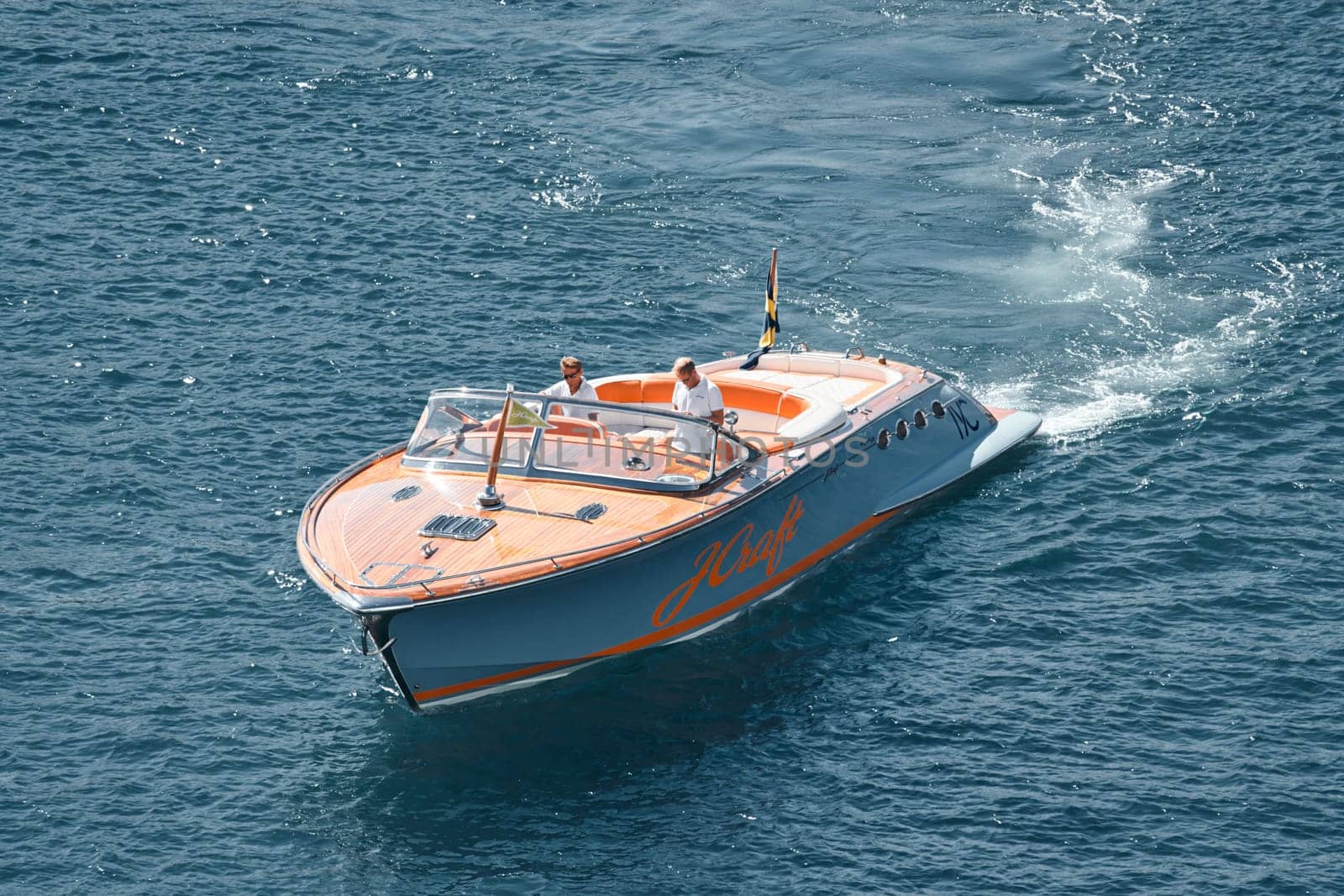 a boat with guests of yacht brokers departs from the shore in the largest fair exhibition in the world yacht show MYS, port Hercules, rich clients, sunny by vladimirdrozdin