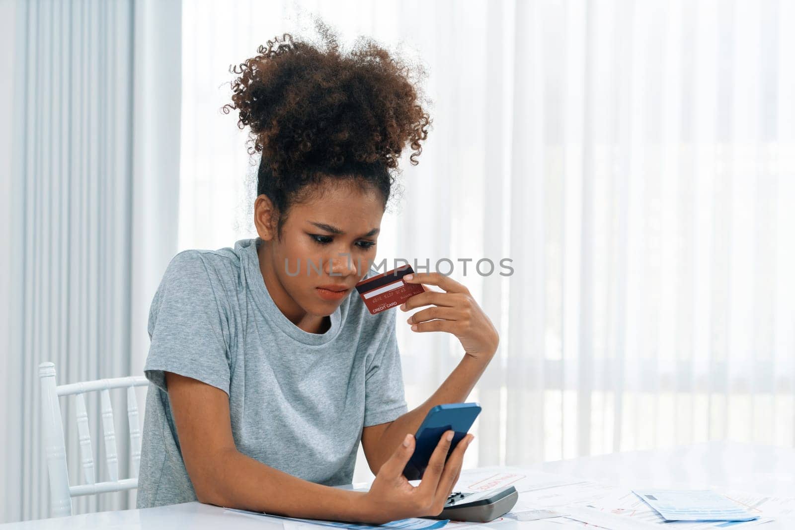 Stressed young woman has financial problems credit card debt to pay crucial by biancoblue