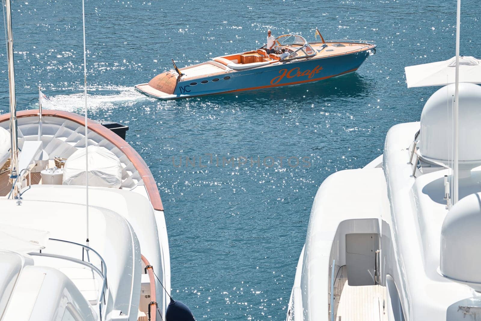 Monaco, Monte Carlo, 28 September 2022 - a boat with guests of yacht brokers departs from the shore in the largest fair exhibition in the world yacht show MYS, port Hercules, rich clients, sunny. High quality photo