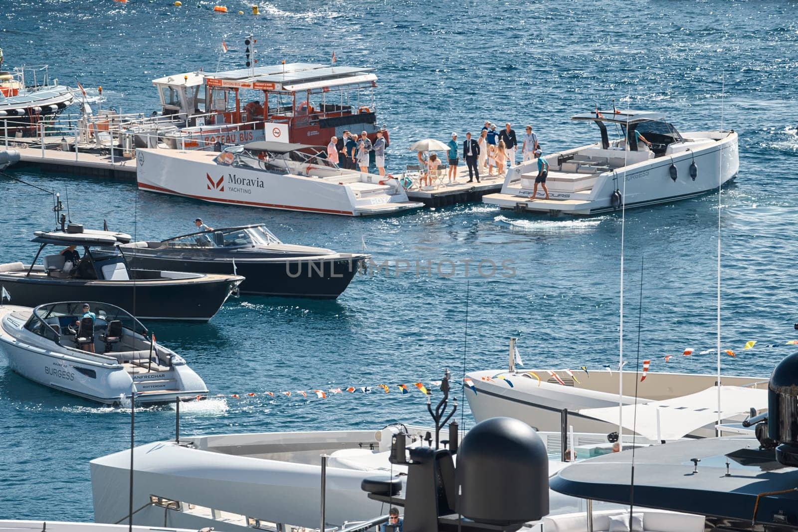 Monaco, Monte Carlo, 28 September 2022 - a boat with guests of yacht brokers departs from the shore in the largest fair exhibition in the world yacht show MYS, port Hercules, rich clients, sunny. High quality photo